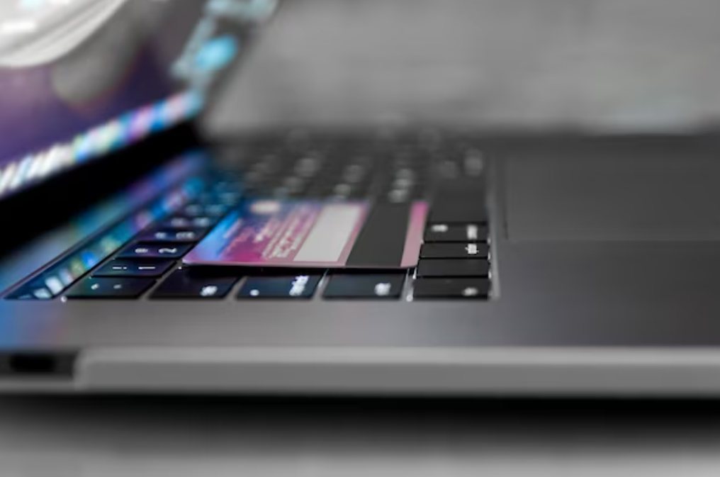 a side view of the opened silver laptop and keyboard