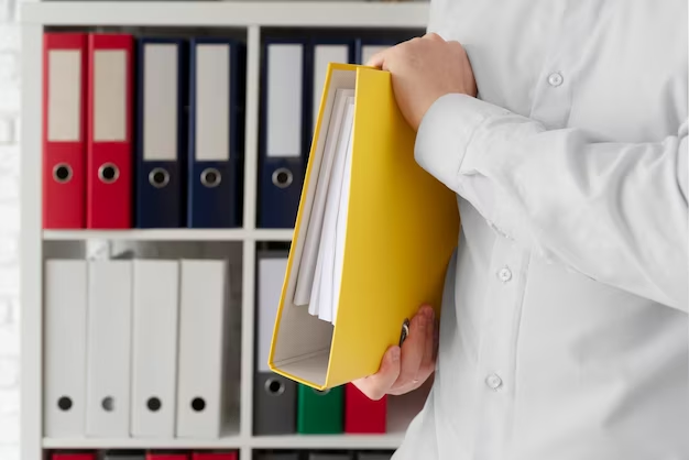 A person standing with a folder for documents